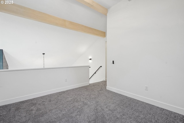 spare room with carpet, baseboards, and lofted ceiling with beams