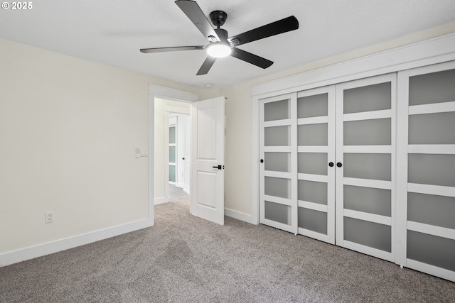 unfurnished bedroom featuring carpet floors, ceiling fan, and baseboards