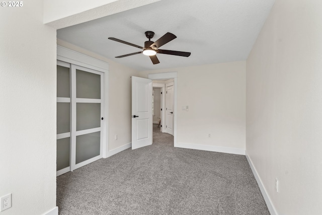 unfurnished bedroom with carpet floors, baseboards, and ceiling fan