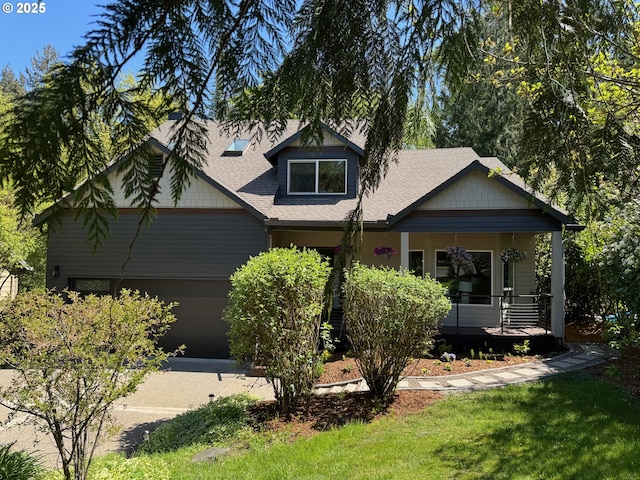 craftsman inspired home featuring a porch, an attached garage, and a shingled roof
