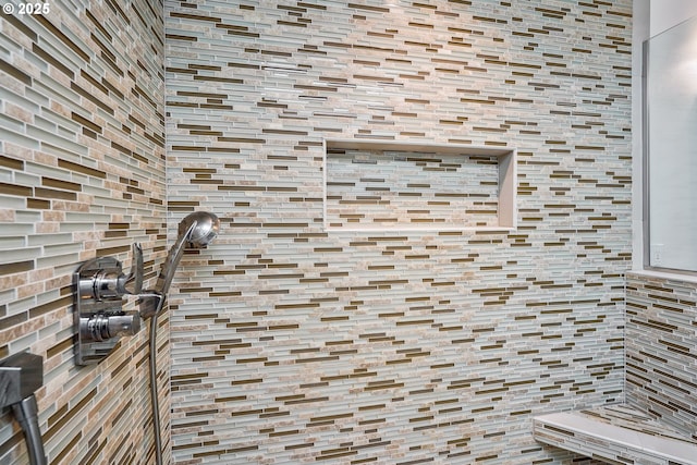 interior details featuring a tile shower