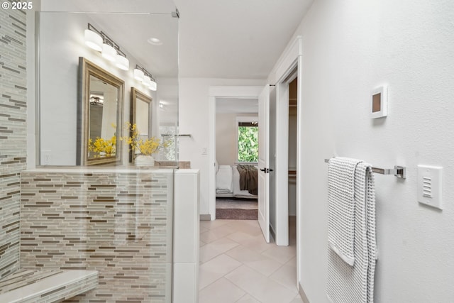 ensuite bathroom with tile patterned flooring and connected bathroom