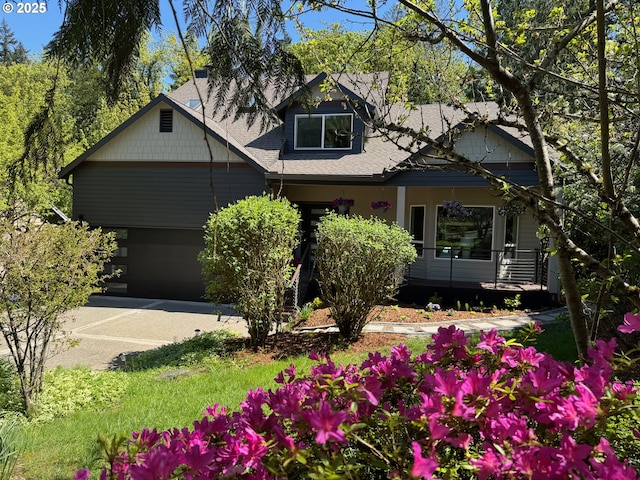 view of front facade with driveway, a garage, and covered porch