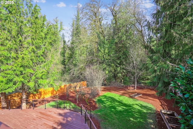 surrounding community with a yard and a deck