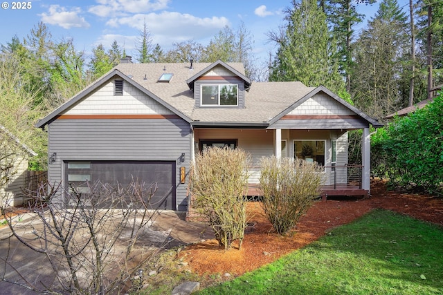 view of front of home with a garage, driveway, a shingled roof, and a porch