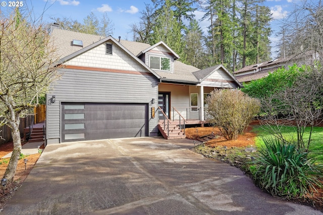 view of front of property featuring a garage, concrete driveway, a porch, and a shingled roof