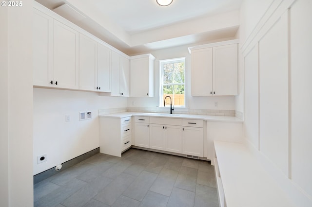 washroom featuring hookup for a washing machine, a sink, and cabinet space