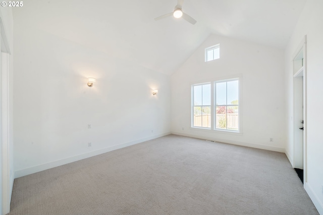carpeted empty room featuring a ceiling fan, high vaulted ceiling, visible vents, and baseboards
