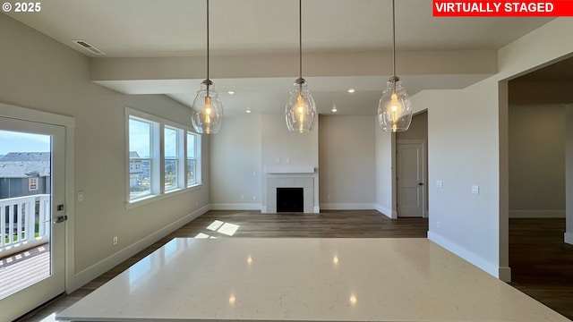 unfurnished living room featuring recessed lighting, dark wood finished floors, visible vents, baseboards, and a fireplace