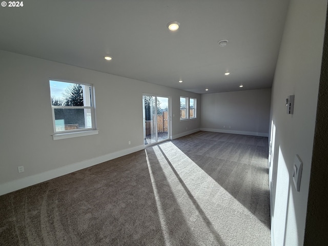 carpeted empty room featuring baseboards and recessed lighting