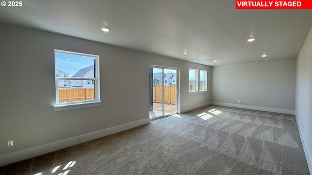 empty room featuring recessed lighting, carpet, and baseboards