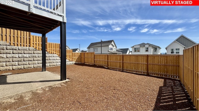 view of yard with a residential view and a fenced backyard