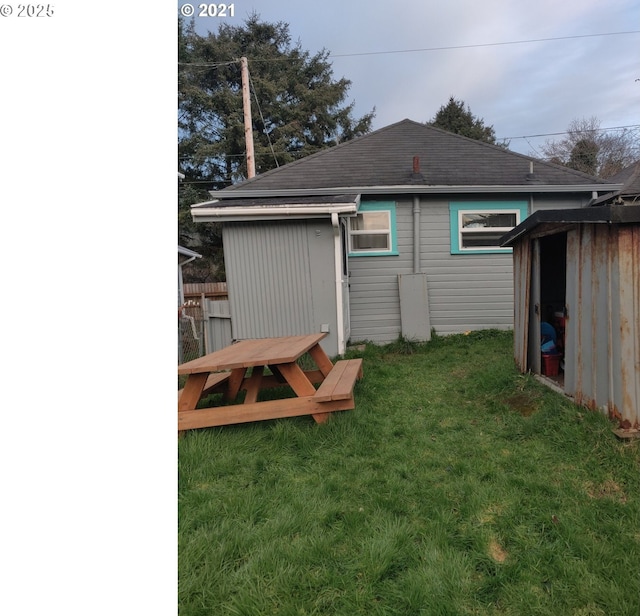 317 N Beacon St, Rockaway Beach, OR 97136 - back of house featuring a yard