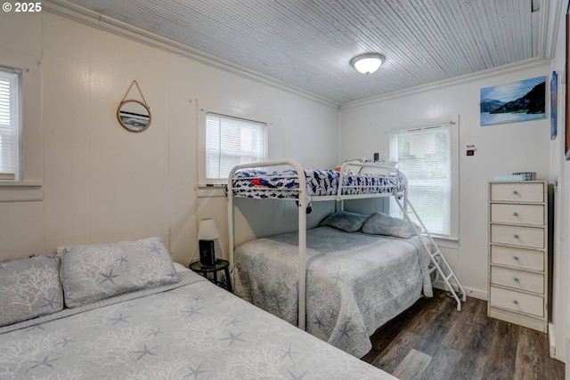 317 N Beacon St, Rockaway Beach, OR 97136 - bedroom featuring dark wood-type flooring, multiple windows, and crown molding