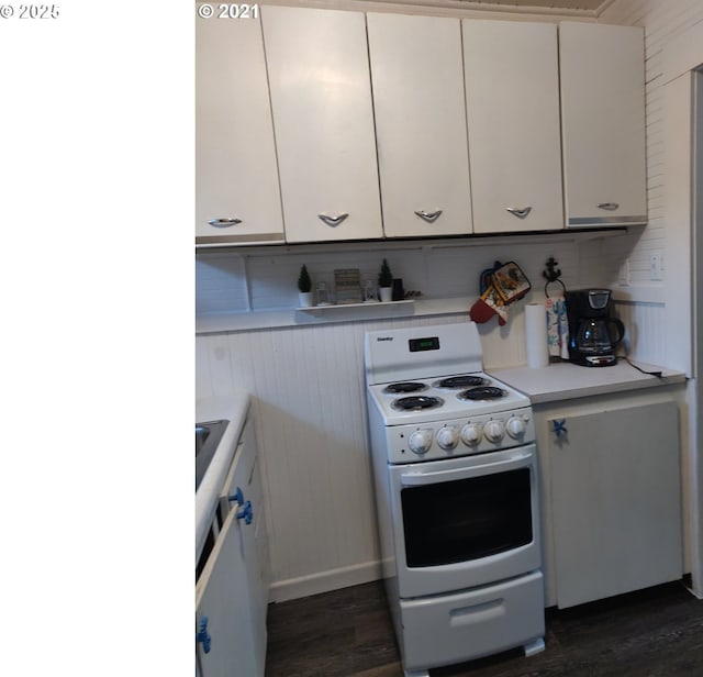 317 N Beacon St, Rockaway Beach, OR 97136 - kitchen with white cabinets, dark hardwood / wood-style flooring, white range with gas cooktop, and backsplash