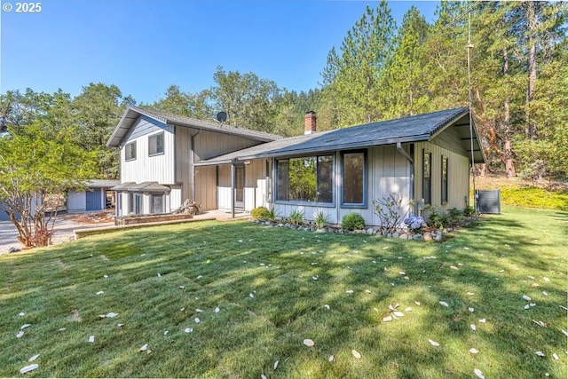 3755 Hosmer Ln, Gold Hill, OR 97525 - split level home featuring a chimney, a front yard, and central AC unit