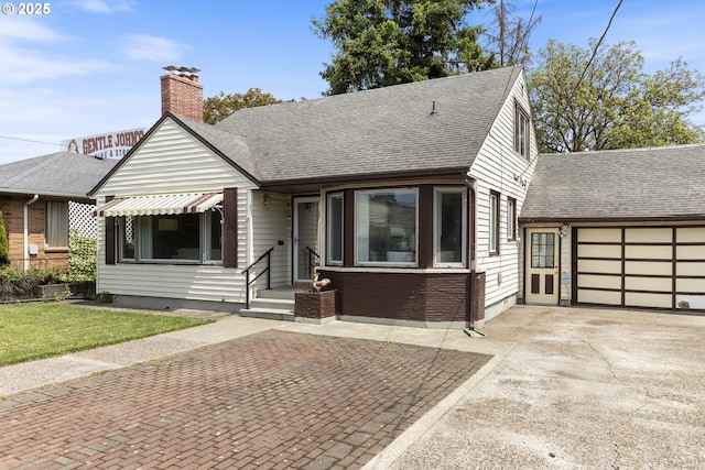 1408 NE 114th Ave, Portland, OR 97220 - view of front of property with concrete driveway, roof with shingles, a chimney, and a front lawn