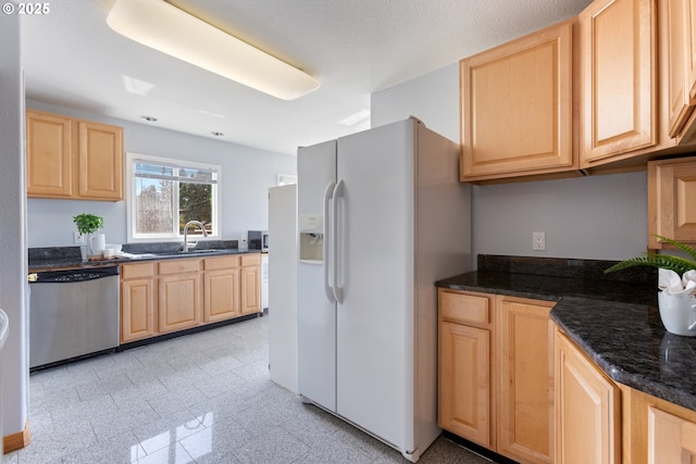 kitchen with light brown cabinetry, dishwasher, white refrigerator with ice dispenser, and granite tiled floors