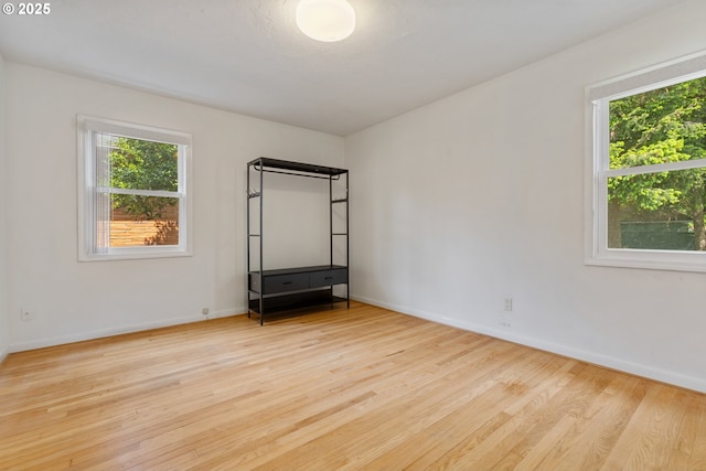 spare room featuring wood finished floors and baseboards