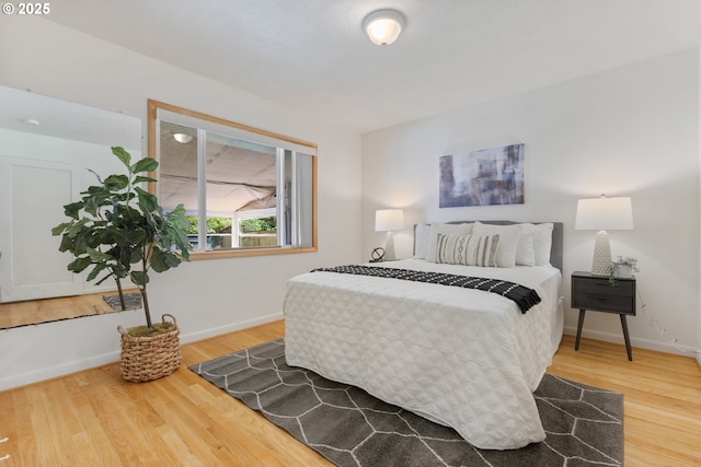 bedroom with wood finished floors and baseboards