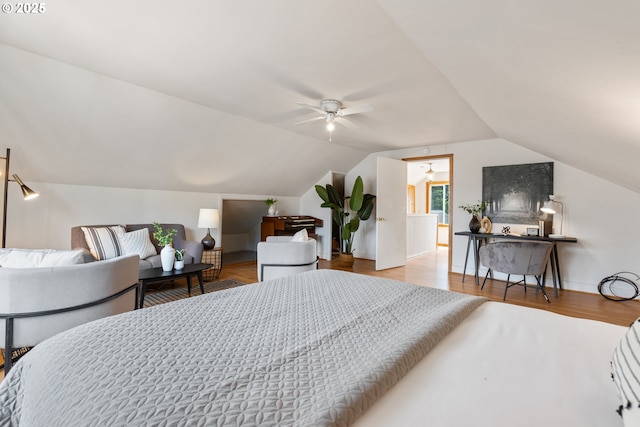 bedroom with lofted ceiling and wood finished floors