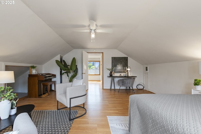 bedroom with light wood finished floors and vaulted ceiling