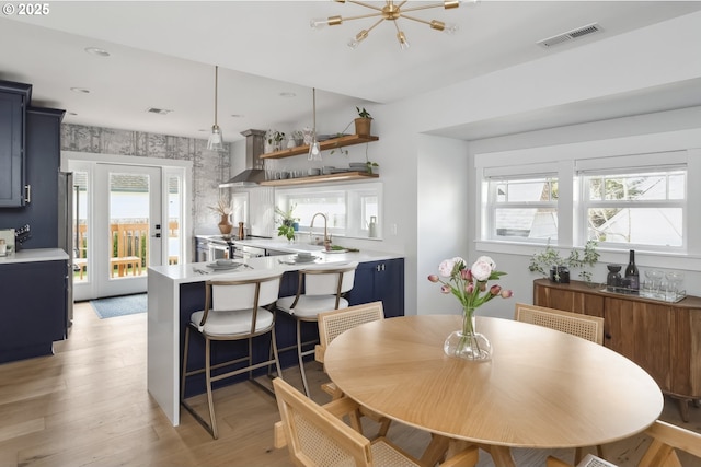 dining space with light wood-type flooring, visible vents, a chandelier, and recessed lighting