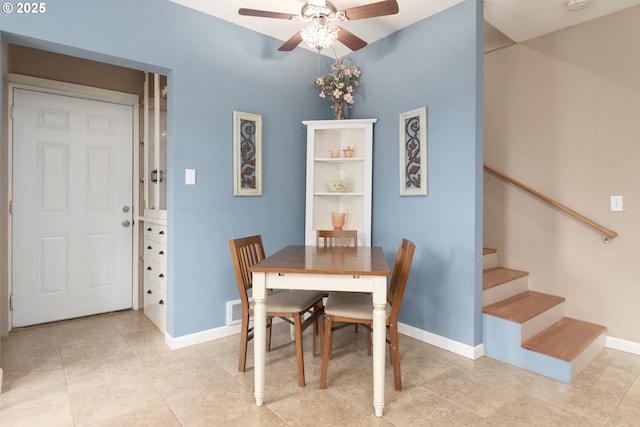 dining room featuring a ceiling fan, baseboards, stairs, and light tile patterned flooring
