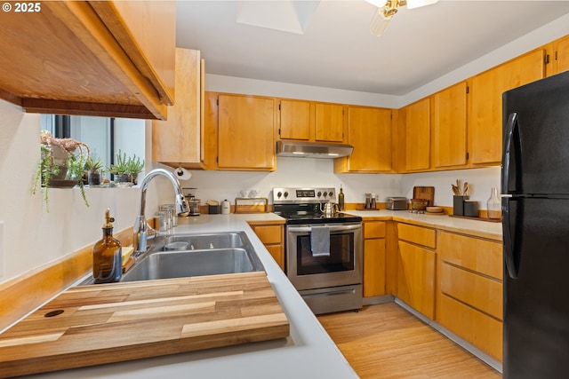 9 N 20th St, Hood River, OR 97031 - kitchen with freestanding refrigerator, stainless steel electric range oven, a sink, under cabinet range hood, and light wood-type flooring