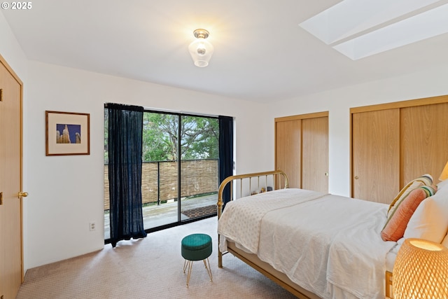 9 N 20th St, Hood River, OR 97031 - bedroom with access to exterior, a skylight, light colored carpet, and multiple closets