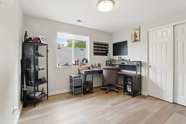 office space with wood finished floors and baseboards