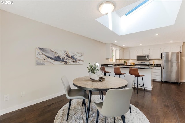 180 Nelson Ln, Gladstone, OR 97027 - dining area with a skylight, baseboards, dark wood-type flooring, and recessed lighting