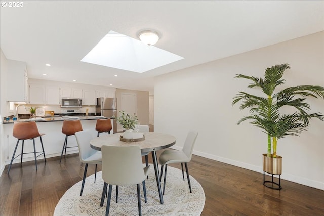 180 Nelson Ln, Gladstone, OR 97027 - dining space with a skylight, dark wood-style flooring, recessed lighting, and baseboards