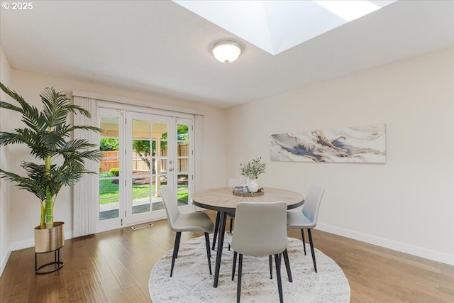 180 Nelson Ln, Gladstone, OR 97027 - dining space with baseboards, wood finished floors, a skylight, and french doors