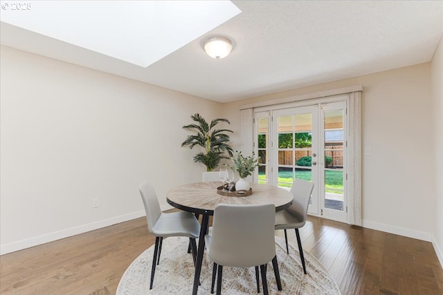 180 Nelson Ln, Gladstone, OR 97027 - dining space featuring baseboards, wood finished floors, and a skylight
