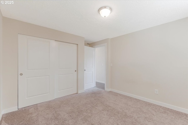 180 Nelson Ln, Gladstone, OR 97027 - unfurnished bedroom featuring carpet, a closet, baseboards, and a textured ceiling