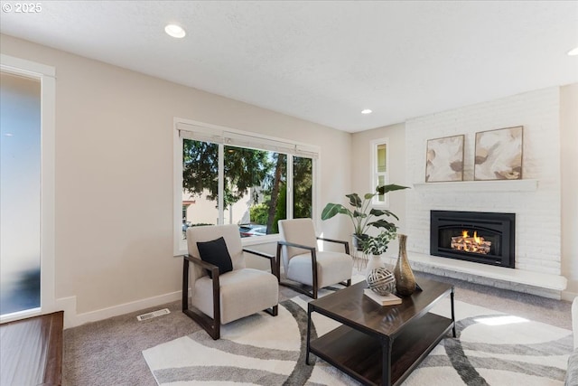 180 Nelson Ln, Gladstone, OR 97027 - carpeted living room featuring a fireplace, baseboards, and recessed lighting