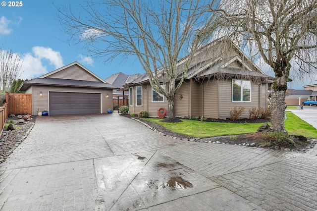 single story home with a garage, fence, and a front lawn