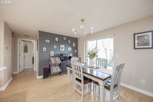 dining room with a notable chandelier and light hardwood / wood-style flooring