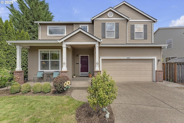 16085 SW Towhee Ln, Beaverton, OR 97007 - view of front of house with a porch, a garage, driveway, and brick siding