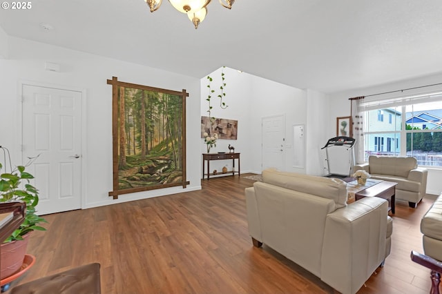 16085 SW Towhee Ln, Beaverton, OR 97007 - living area featuring wood finished floors, a chandelier, and baseboards