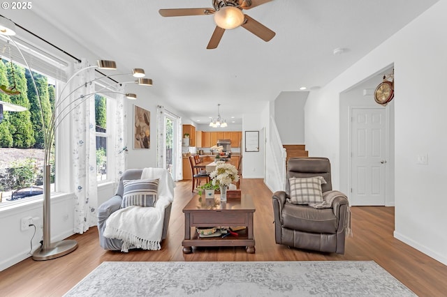 16085 SW Towhee Ln, Beaverton, OR 97007 - living room with light wood-style flooring, a chandelier, ceiling fan, baseboards, and recessed lighting