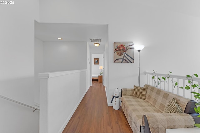 16085 SW Towhee Ln, Beaverton, OR 97007 - hallway featuring wood finished floors, baseboards, recessed lighting, and an upstairs landing