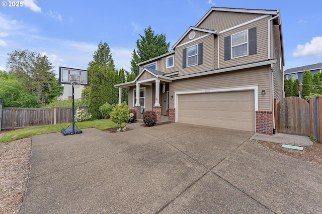 16085 SW Towhee Ln, Beaverton, OR 97007 - view of front of home with brick siding, concrete driveway, a garage, and covered porch