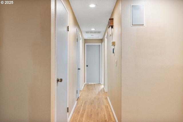 hall featuring recessed lighting, light wood-style floors, visible vents, and baseboards