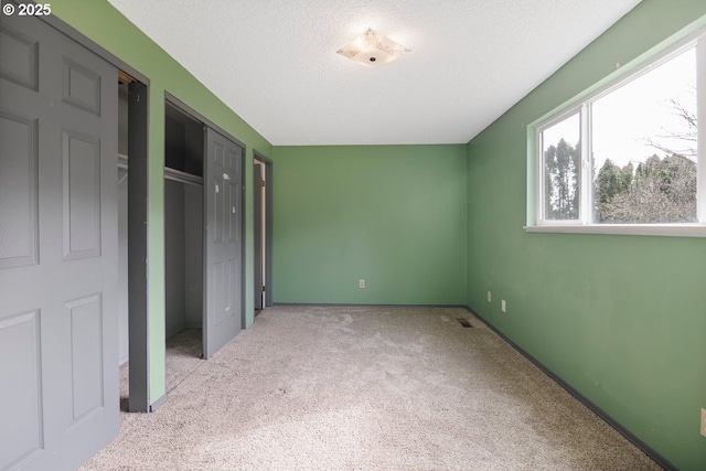 unfurnished bedroom with a closet, a textured ceiling, and carpet flooring