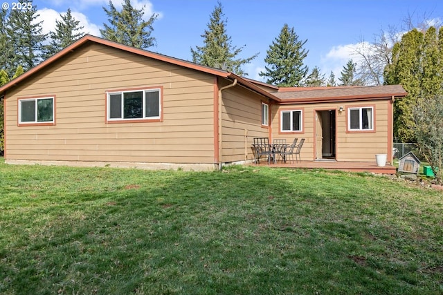 rear view of house with a yard