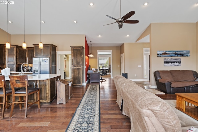 living room with vaulted ceiling, ceiling fan, dark wood-style floors, baseboards, and recessed lighting
