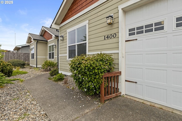 view of exterior entry featuring fence