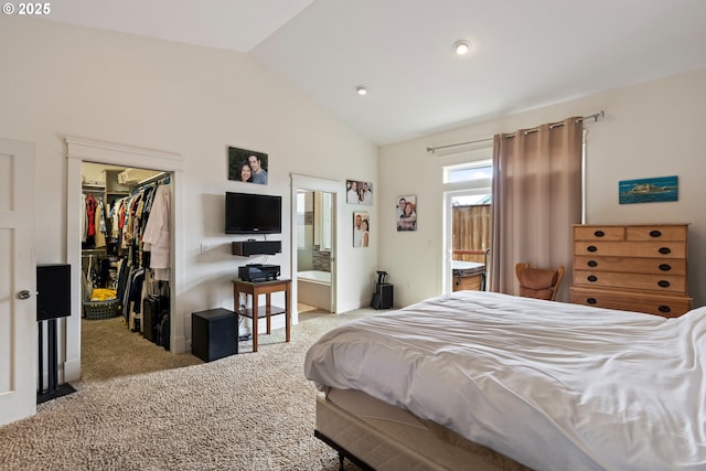 carpeted bedroom with lofted ceiling, a spacious closet, a closet, and ensuite bathroom